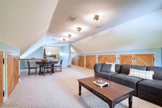 living room with vaulted ceiling and light colored carpet