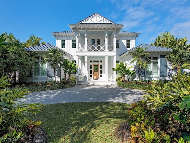 view of front facade with a balcony and a front lawn