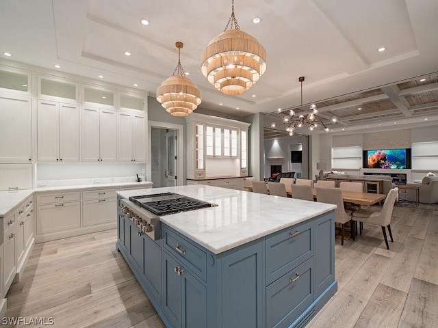 kitchen with white cabinetry, hanging light fixtures, and stainless steel gas stovetop