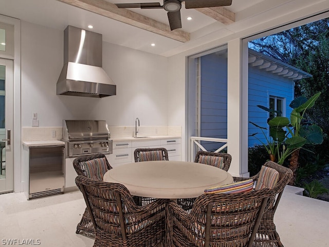 interior space featuring beam ceiling, ceiling fan, and sink