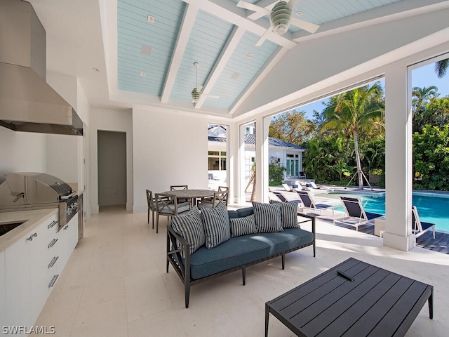 view of patio / terrace featuring grilling area, ceiling fan, and an outdoor kitchen