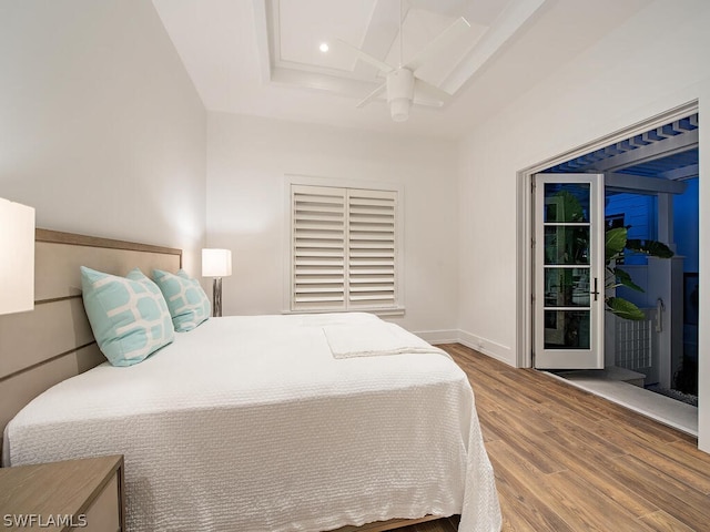 bedroom with access to outside and wood-type flooring