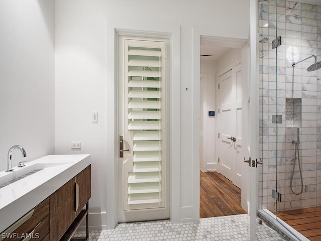 bathroom featuring tile patterned floors, vanity, and a shower with shower door