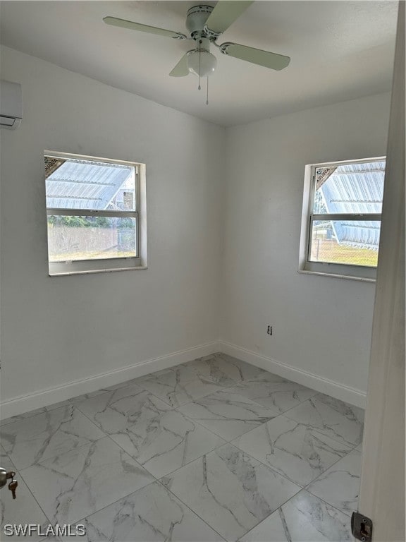 spare room featuring a wall mounted air conditioner and ceiling fan