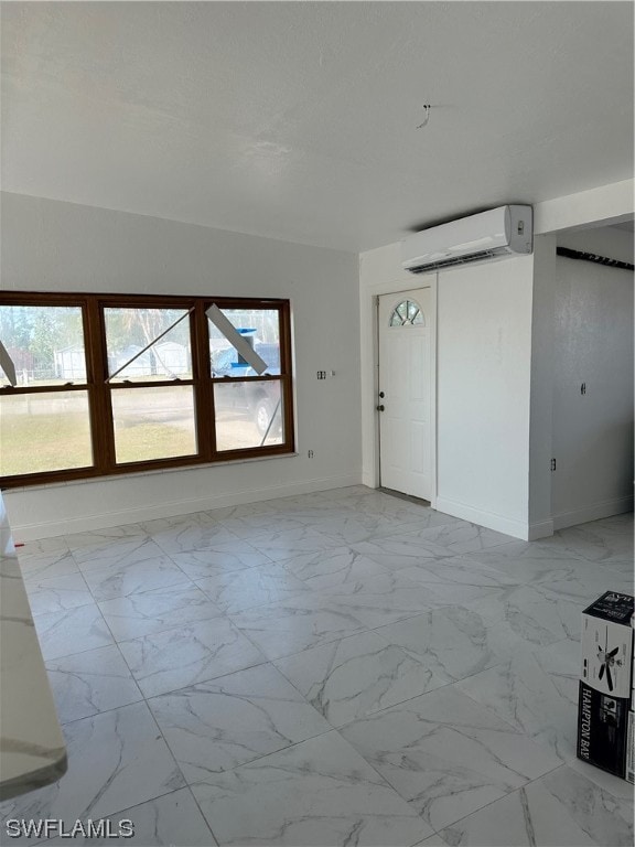 empty room featuring plenty of natural light and a wall unit AC