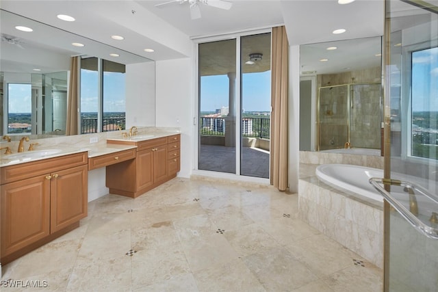 bathroom featuring ceiling fan, vanity, and separate shower and tub