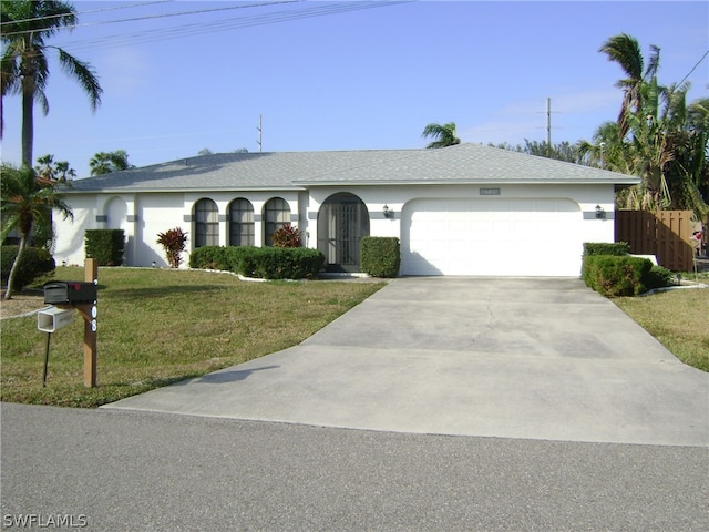 ranch-style house with a front yard and a garage