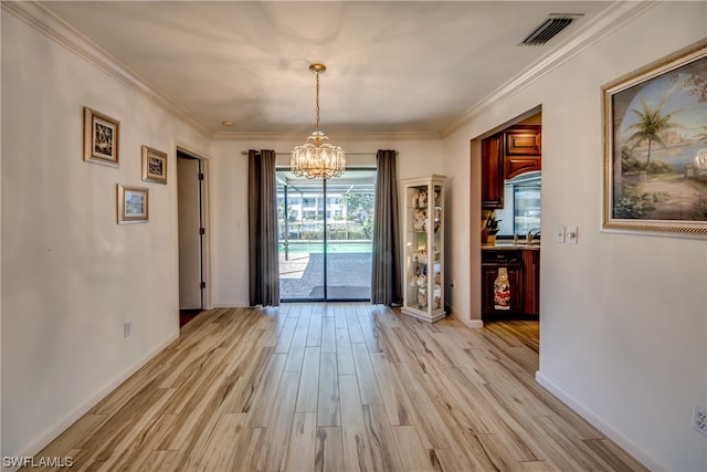 unfurnished dining area featuring ornamental molding, a notable chandelier, and light hardwood / wood-style flooring