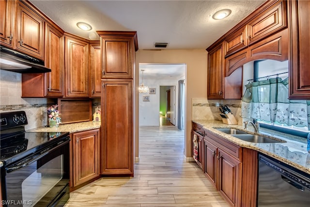 kitchen with backsplash, black appliances, light hardwood / wood-style floors, sink, and light stone counters