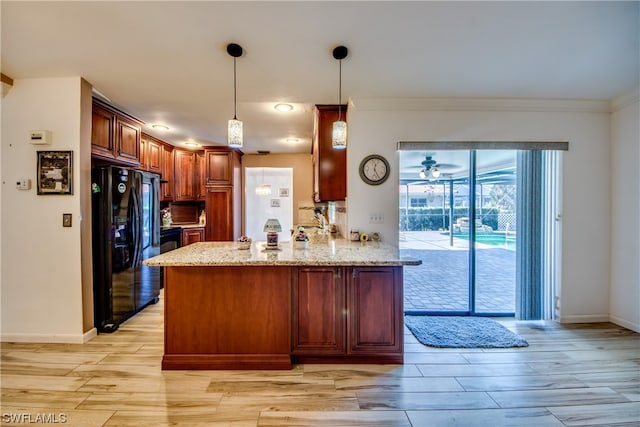 kitchen featuring pendant lighting, ceiling fan, light hardwood / wood-style flooring, black fridge with ice dispenser, and light stone counters