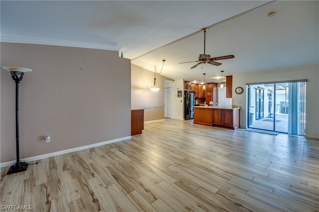 unfurnished living room featuring ornamental molding, lofted ceiling, ceiling fan, and light wood-type flooring