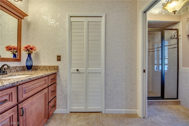 bathroom with an enclosed shower, tile floors, and vanity