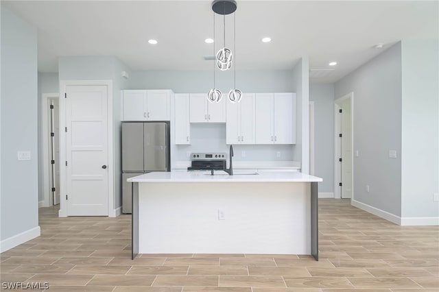 kitchen featuring a center island with sink, white cabinets, sink, and appliances with stainless steel finishes