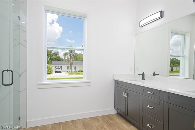 bathroom featuring vanity and an enclosed shower