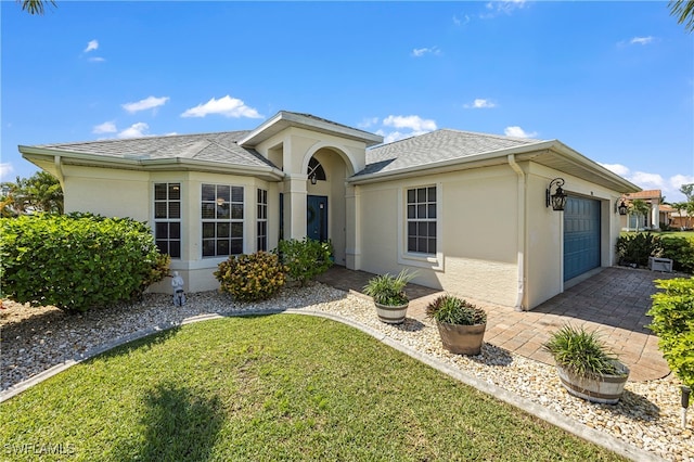 view of front of house with a front yard and a garage