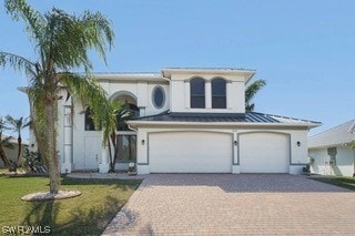 view of front facade with a front yard and a garage