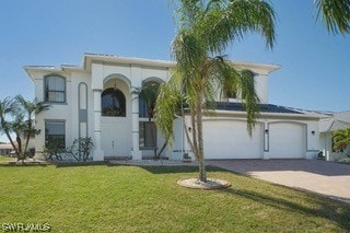 mediterranean / spanish-style house with a front yard