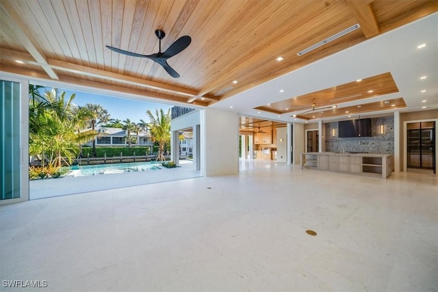 unfurnished living room featuring a raised ceiling, wood ceiling, a ceiling fan, and recessed lighting