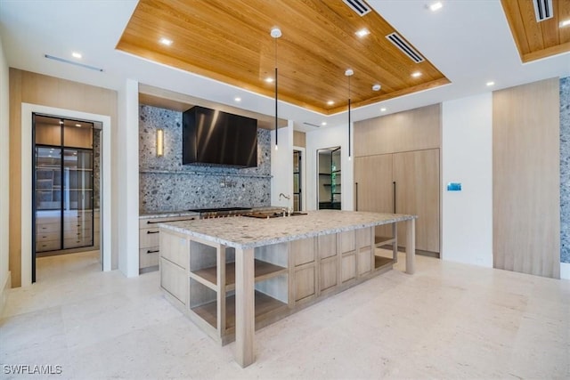 kitchen with a raised ceiling, wood ceiling, and modern cabinets