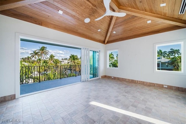 spare room featuring baseboards, vaulted ceiling, a ceiling fan, and wood ceiling