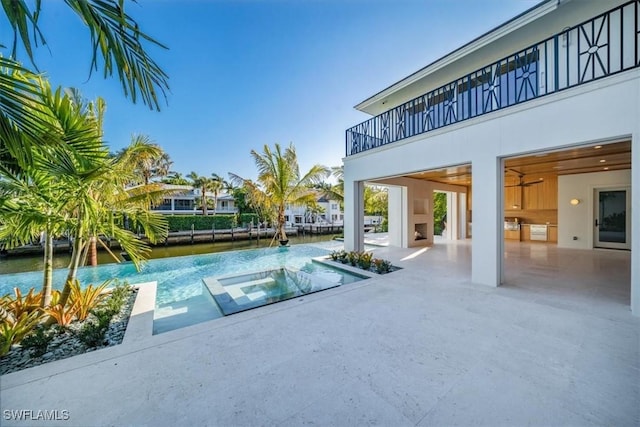 view of pool with a water view and a patio area