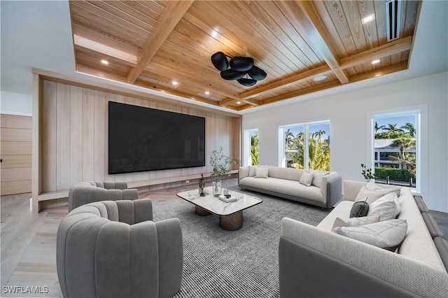 living area with coffered ceiling, wooden ceiling, beam ceiling, and a healthy amount of sunlight