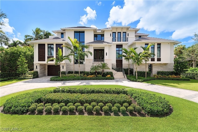 view of front facade with a front lawn and a garage