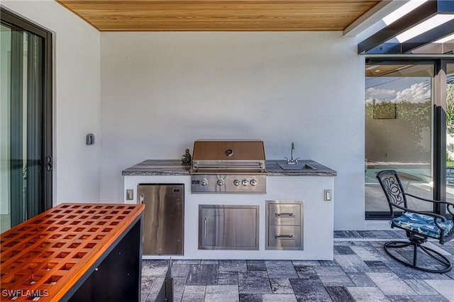 view of patio / terrace with an outdoor kitchen, area for grilling, and a sink