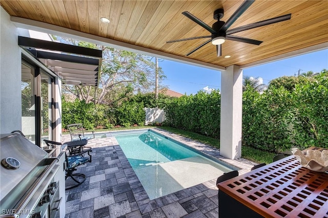 view of pool with a fenced in pool, area for grilling, a patio, ceiling fan, and a fenced backyard