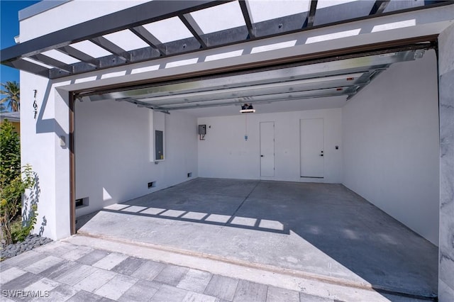 garage with a garage door opener and electric panel