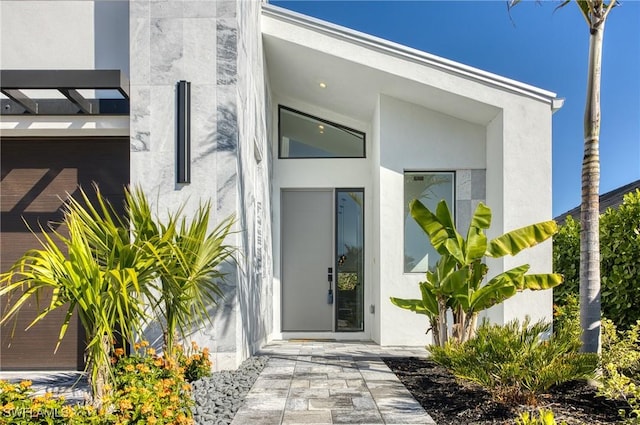 doorway to property with stucco siding