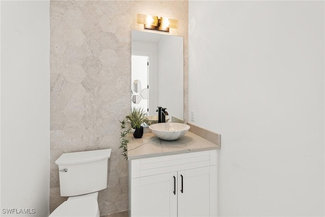 bathroom featuring toilet and vanity