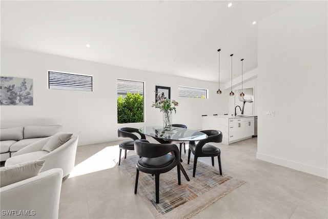 dining room with baseboards and recessed lighting