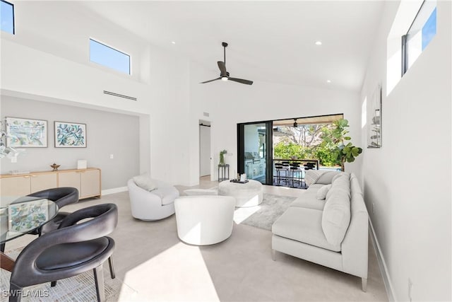 living area featuring a wealth of natural light, a towering ceiling, and recessed lighting