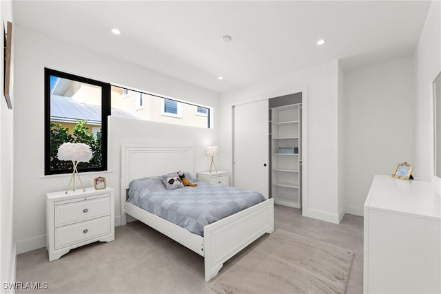 bedroom featuring baseboards, a closet, and recessed lighting