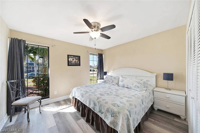 bedroom with ceiling fan and dark hardwood / wood-style flooring