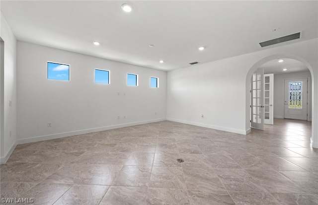 unfurnished room with light tile floors