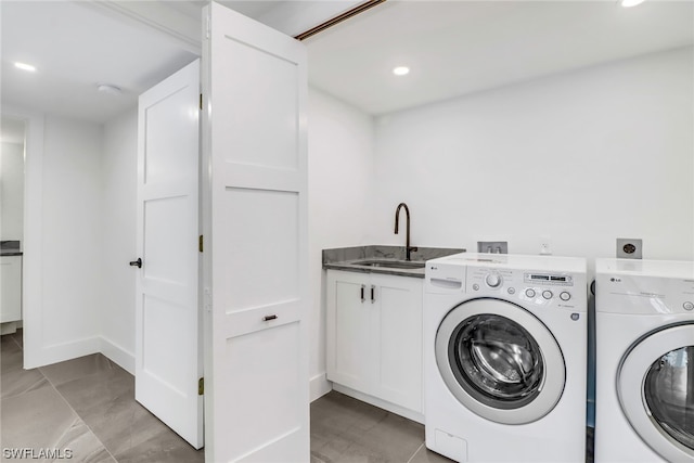 clothes washing area with light tile flooring, cabinets, hookup for an electric dryer, sink, and separate washer and dryer