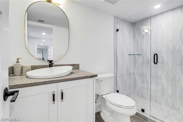 bathroom with toilet, walk in shower, and oversized vanity