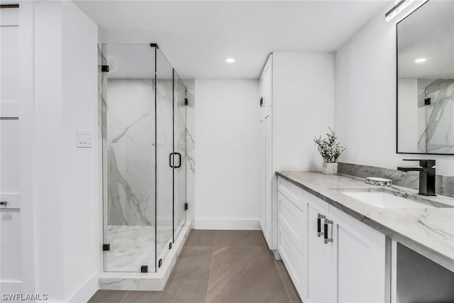 bathroom featuring tile flooring, walk in shower, and vanity