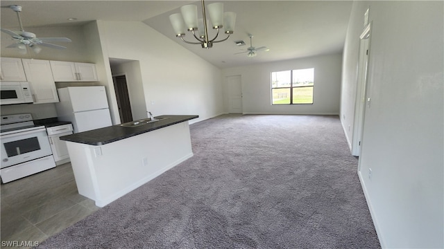 kitchen with white appliances, white cabinets, dark colored carpet, high vaulted ceiling, and ceiling fan with notable chandelier