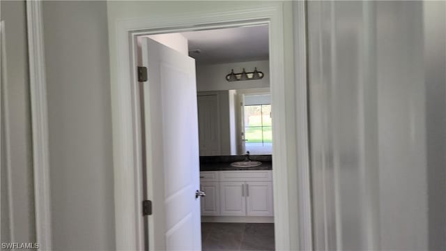 corridor with dark tile flooring