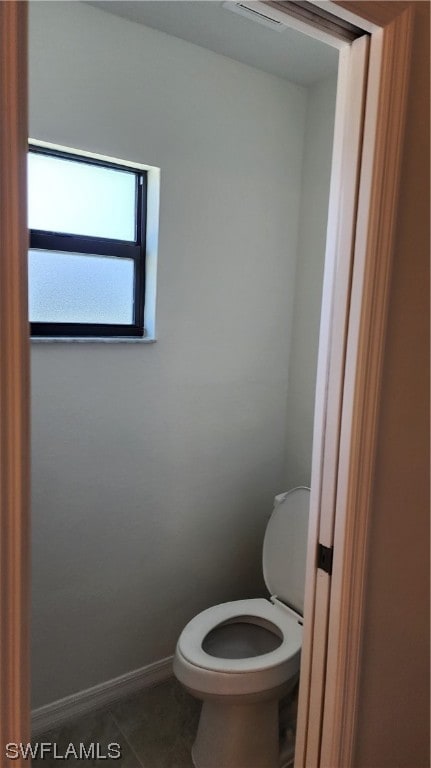 bathroom featuring toilet and tile flooring