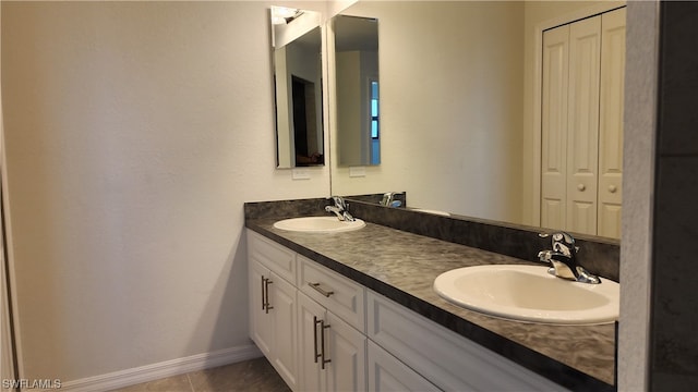 bathroom with double vanity and tile flooring