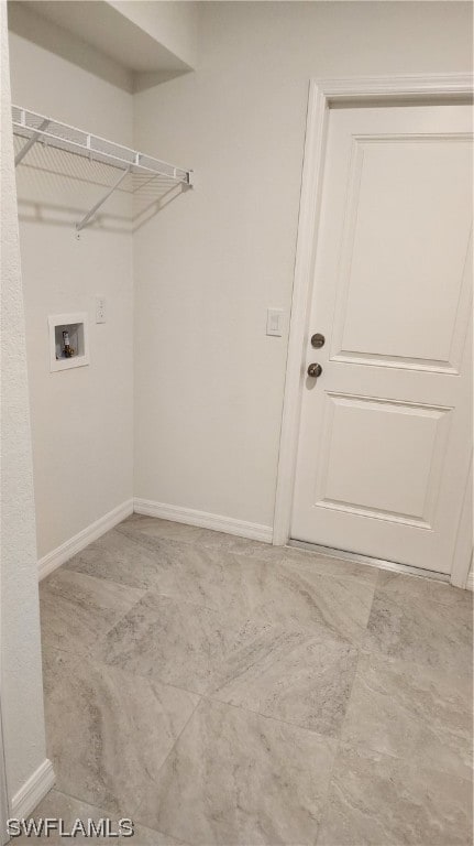 washroom featuring washer hookup and light tile floors