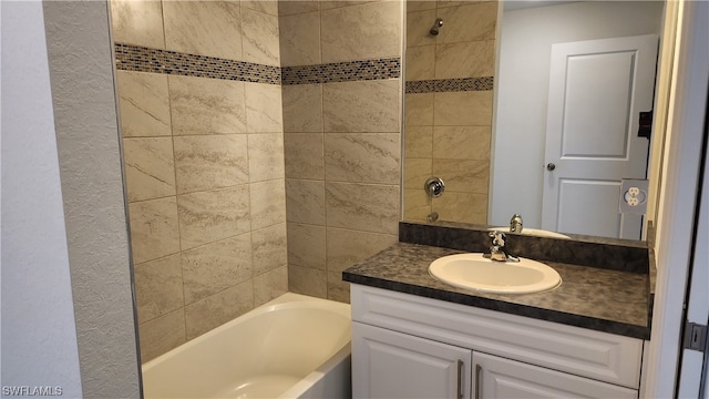 bathroom with vanity and tiled shower / bath combo