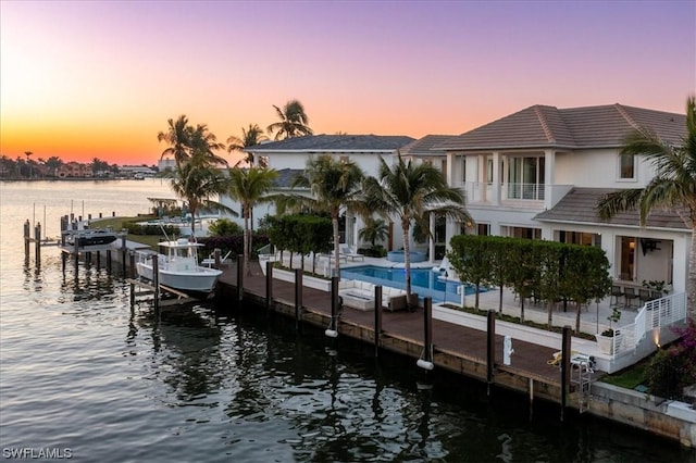 view of dock featuring a balcony and a water view