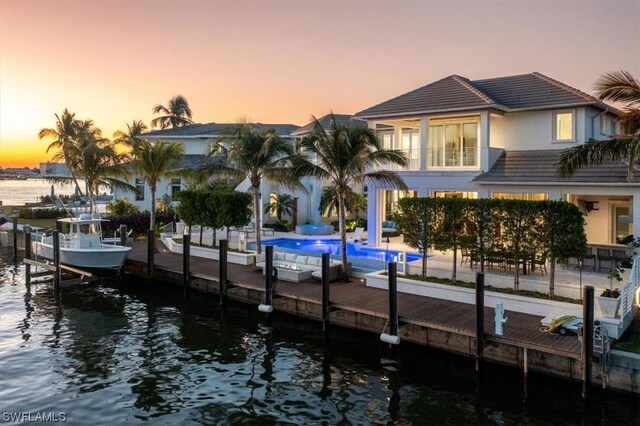 dock area featuring a water view and a balcony