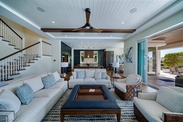 living room with ceiling fan, wood-type flooring, and wooden ceiling