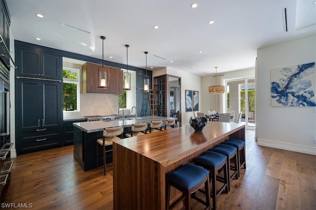 kitchen with a breakfast bar area, a center island, and a healthy amount of sunlight